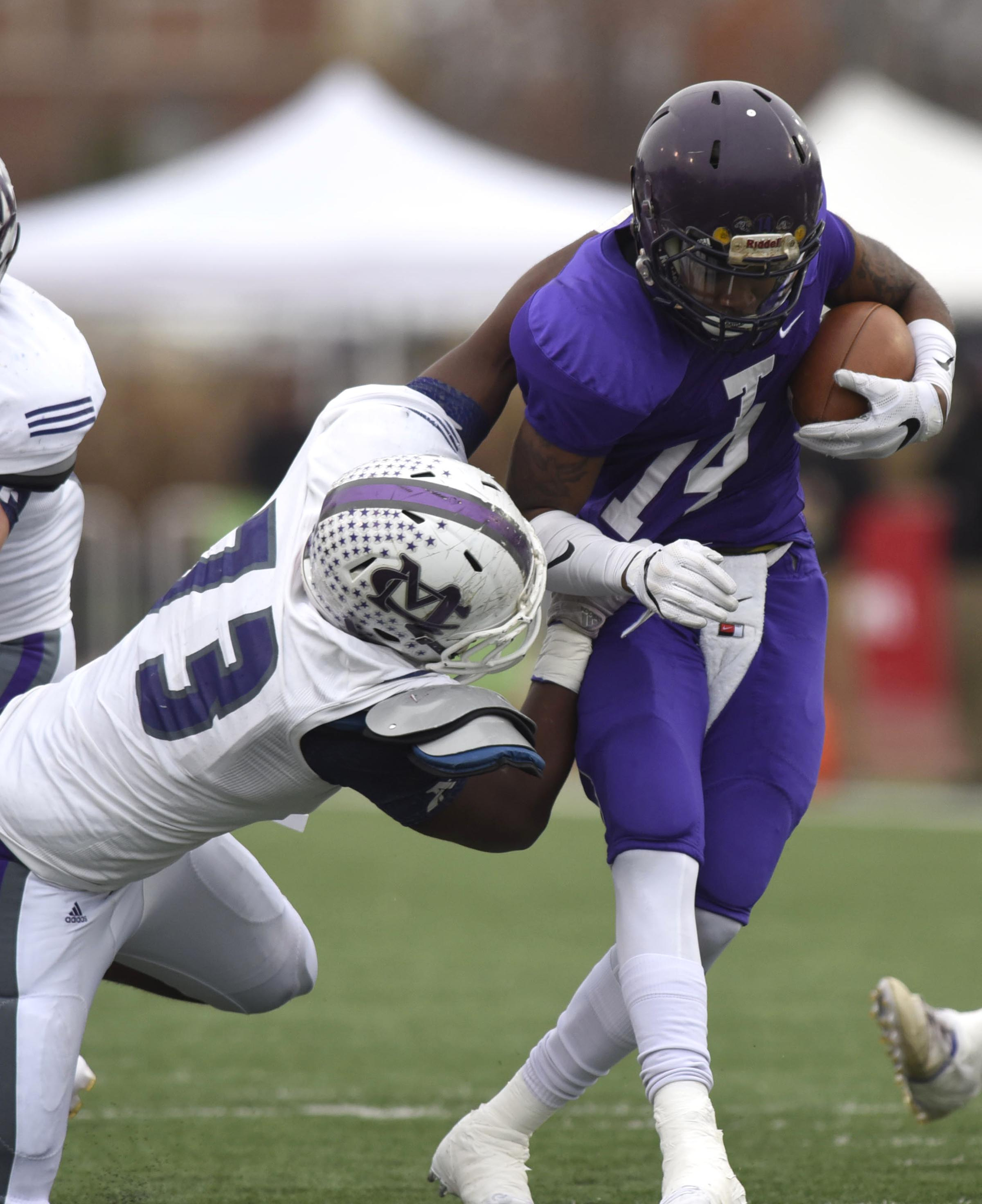 Trezevant quarterback Tywon Johnson (14) is tackled by Marion County's ICory Tucker (73). The Marion County Warriors faced the Memphis Trezevant Bears in the Class AA TSSAA State Football Championship played in the BlueCross Bowl at Tennessee Tech in Cookeville on December 3, 2016.