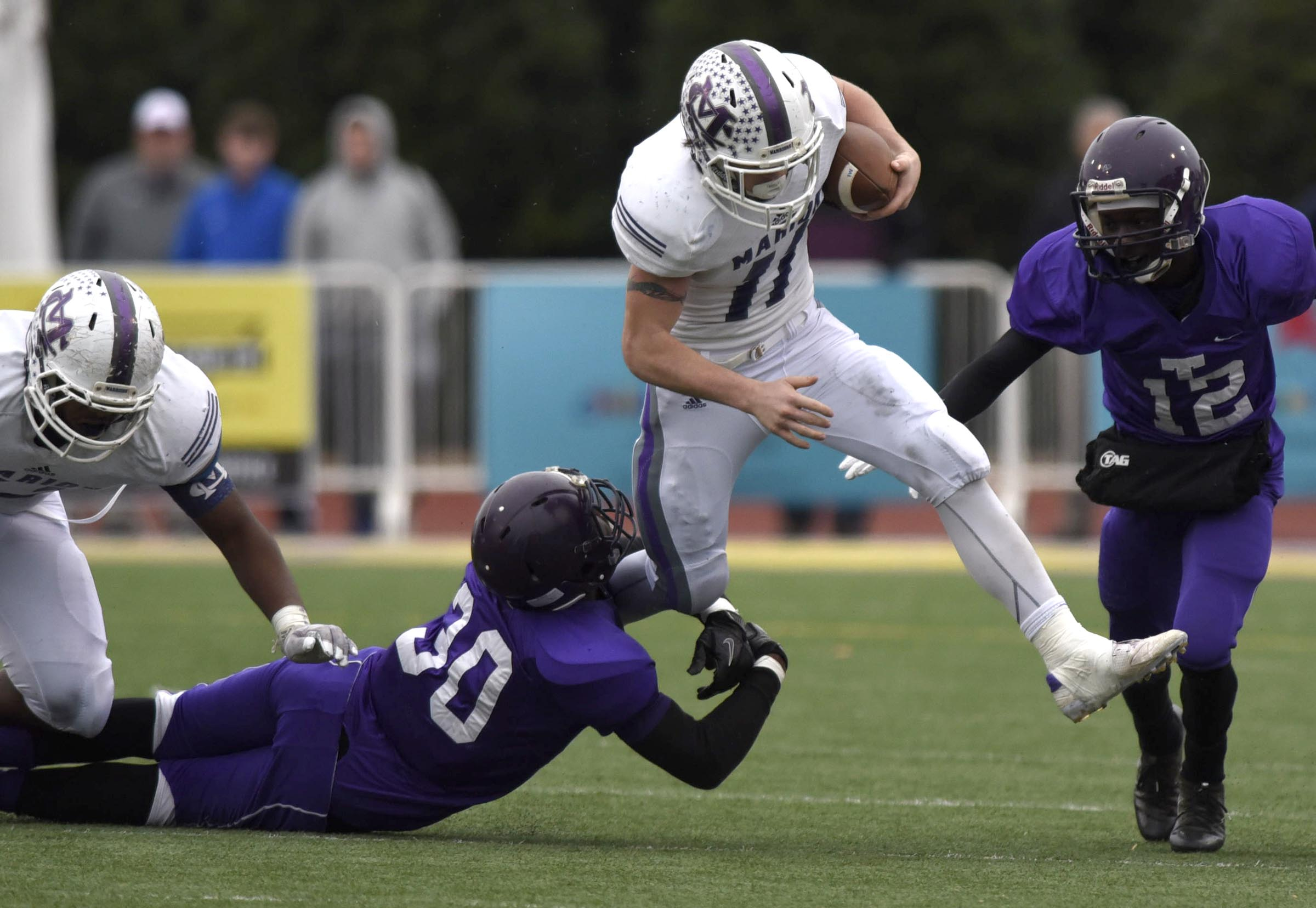 Marion County's Hunter Zeman (11) tries to leap over a Bear tackler. The Marion County Warriors faced the Memphis Trezevant Bears in the Class AA TSSAA State Football Championship played in the BlueCross Bowl at Tennessee Tech in Cookeville on December 3, 2016.
