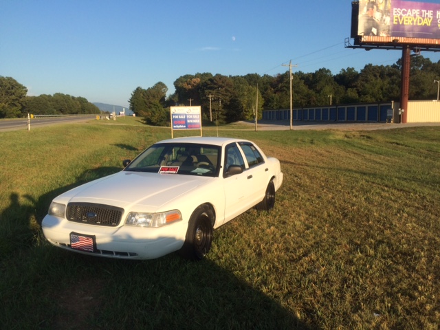 Cars for sale in front of the Benton Police Department in Polk County.