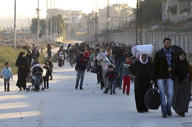 
              FILE - In this Sunday, Nov. 27, 2016 file photo provided by the Rumaf, a Syrian Kurdish activist group, which has been authenticated based on its contents and other AP reporting, shows people fleeing rebel-held eastern neighborhoods of Aleppo into the Sheikh Maqsoud area that is controlled by Kurdish fighters, Syria. The U.N. humanitarian aid agency said Friday an estimated 31,500 have been displaced from the government advances into the rebel-held enclave since this weekend, in one of the most dramatic shifts in the conflict now in its sixth year. (The Rumaf via AP, File)
            