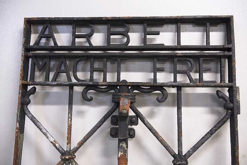 
              The iron gate from the former Nazi concentration camp in Dachau, southern Germany, with the slogan "Arbeit macht frei" ("Work will set you free") is displayed Saturday Dec. 3, 2016, after being found earlier this week by police in Bergen, Norway.  The infamous wrought iron gate was stolen two years ago, and is being cared for by police in Bergen before being returned to Germany. (Marit Hommedal / NTB scanpix via AP)
            