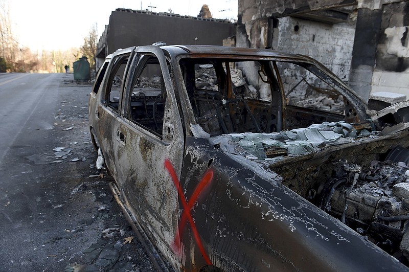 
              A damage car was parked outside of apartments along Cherokee Orchard Rd.  in Gatlinburg, Tenn., Friday, Dec. 2, 2016. Residents on Friday, were getting their first look at what remains of their homes and businesses in Gatlinburg, after a wildfire tore through the resort community on Monday, Nov. 28.  (Amy Smotherman Burgess/Knoxville News Sentinel via AP)
            