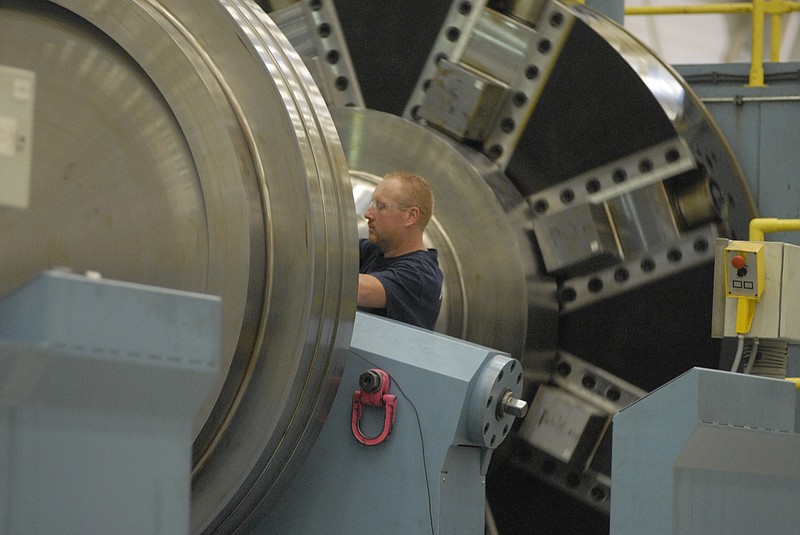 Staff file photo by John Rawlston/ Machinist Brian Higdon works on a turbine component on a horizontal lathe at the Chattanooga Alstom plant in this file photo.