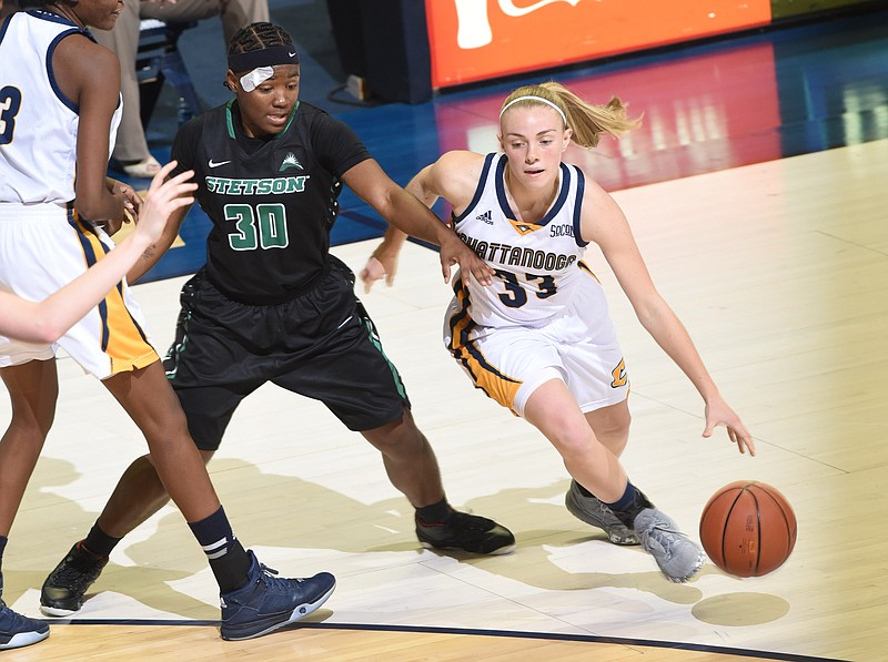 UTC's Lakelyn Bouldin (33) break for the basket around Stetson's Brittney Chambers (30) as Jasmine Joyner sets the pick in second half action at McKenzie Arena Monday night. The Lady Mocs won 66-55.