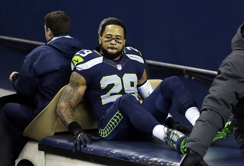 Seattle Seahawks free safety Earl Thomas, left, reaches for a pass