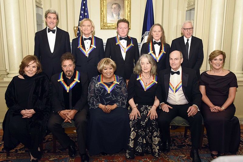 
              Teresa Heinz Kerry, front row, from left, Kennedy Center Honorees Al Pacino, Mavis Staples, Martha Argerich, James Taylor, and Kennedy Center President Deborah Rutter; rear row, from left, Secretary of State John Kerry, Kennedy Center Honorees Joe Walsh, Don Henley, and Timothy Schmit, and David Rubinstein are photographed following the State Department for the Kennedy Center Honors gala dinner, Saturday, Dec. 3, 2016, in Washington. (AP Photo/Kevin Wolf)
            