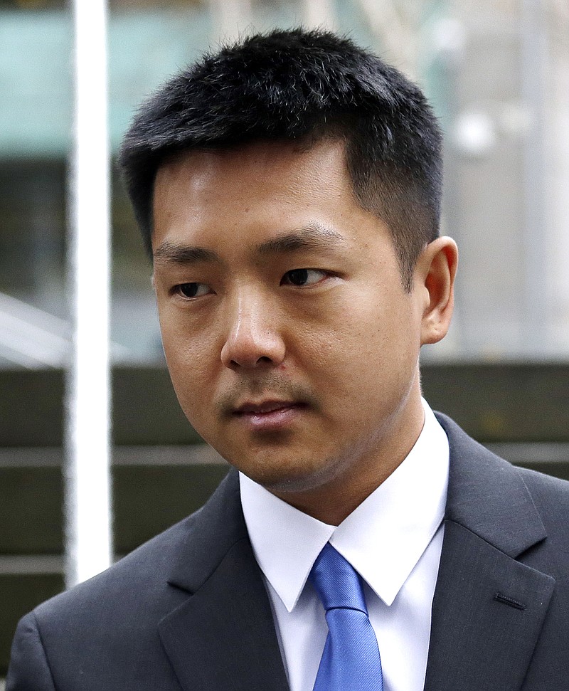 
              Jonathan Ly, left, leaves U.S. District Court in Seattle after pleading guilty to one count of securities fraud, Monday, Dec. 5, 2016. Ly pleaded guilty to allegations that he used his access to the computers of top executives to rummage through their email, then made lucrative illegal stock trades based on the inside information he discovered. (AP Photo/Elaine Thompson)
            