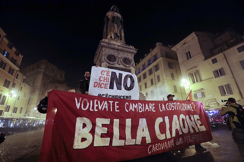 
              Anti-referendum militants gather in downtown Rome after Italian Premier Matteo Renzi conceded defeat in a constitutional referendum and announced he will resign in Rome, early Monday, Dec. 5, 2016. Italians voted Sunday in a referendum on constitutional reforms that Premier Matteo Renzi has staked his political future on. Banner in Italian reads "You wanted to change the Constitution? Goodby Bella". (AP Photo/Gregorio Borgia)
            