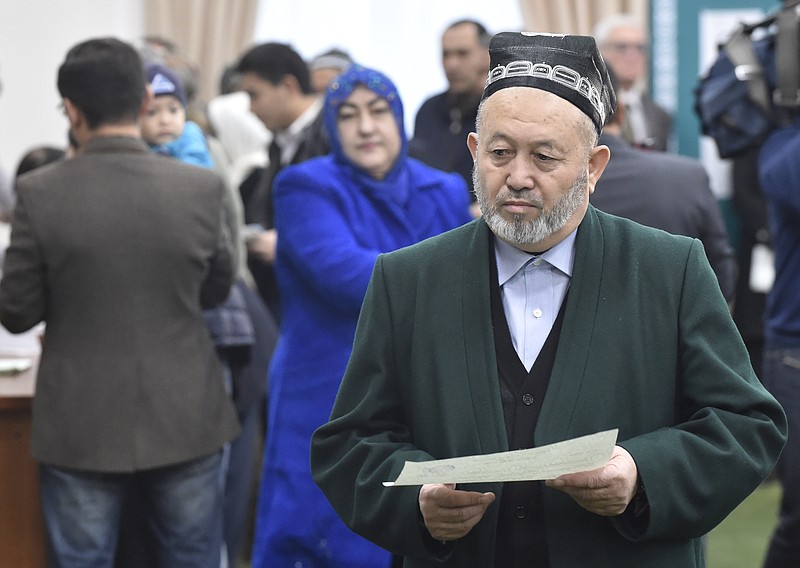 
              A Uzbek man walks to cast his ballot during tightly controlled presidential election, the first vote since the death of authoritarian leader Islam Karimov who ruled the country for 27 years, in Tashkent, Uzbekistan, Sunday Dec. 4, 2016. The odds-on favorite is acting President Shavkat Mirziyoyev, who spent 13 years as Karimov's prime minister. (AP Photo/Anvar Ilyasov)
            