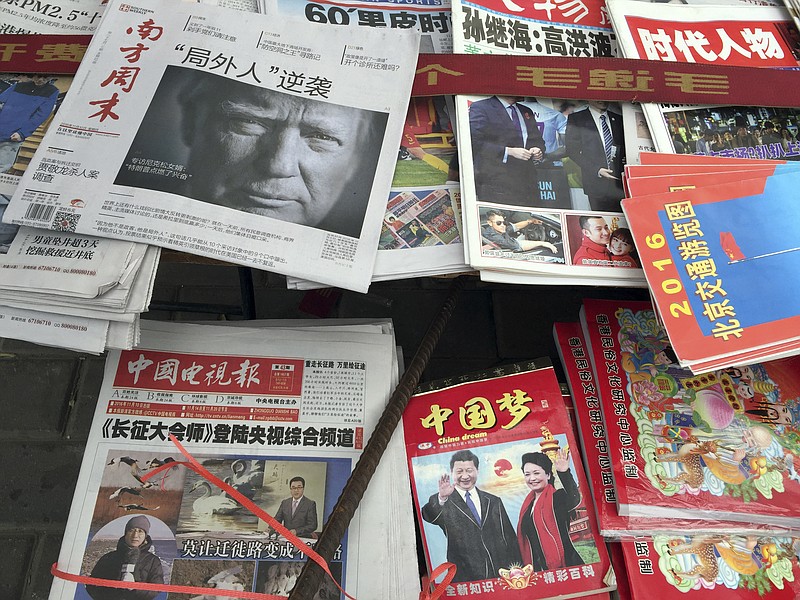 
              FILE - In this Nov. 10, 2016 file photo, a front page of a Chinese newspaper with a photo of U.S. President-elect Donald Trump and the headline "Outsider counter attack" is displayed at a newsstand in Beijing, China. With Trump's latest tweets touching on sensitive issues, China must decide how to handle an incoming American president who relishes confrontation and whose online statements appear to foreshadow shifts in foreign policy. China awoke Monday, Dec. 5, to criticism from Trump on Twitter, days after it responded to his telephone conversation with Taiwan's president by accusing the Taiwanese of playing a "little trick" on Trump. (AP Photo/Ng Han Guan)
            