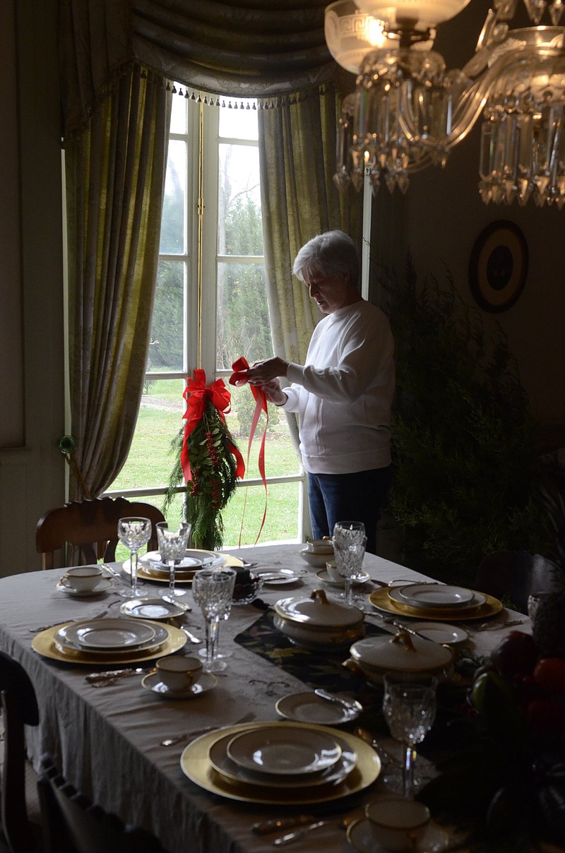 A member of Friends of the Gordon Lee Mansion decorates with natural greenery for a previous year's candlelight tour of the historic Chickamauga, Ga., mansion. This year's tours will be offered 6-8 p.m. Friday and Saturday, Dec. 9-10. The event coincides with Saturday night's Christmas Movie Memories Parade, which concludes the Christmas in the Streets festival in Chickamauga.