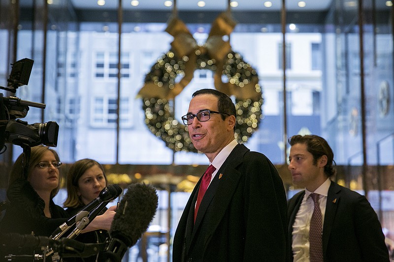 Steven Mnuchin speaks to reporters in the lobby of Trump Tower on Fifth Avenue in Manhattan on Nov. 30. Mnuchin was a partner at Goldman Sachs before founding his own hedge fund and financing big-budget movies; he also served as the Trump campaign's national finance chairman.