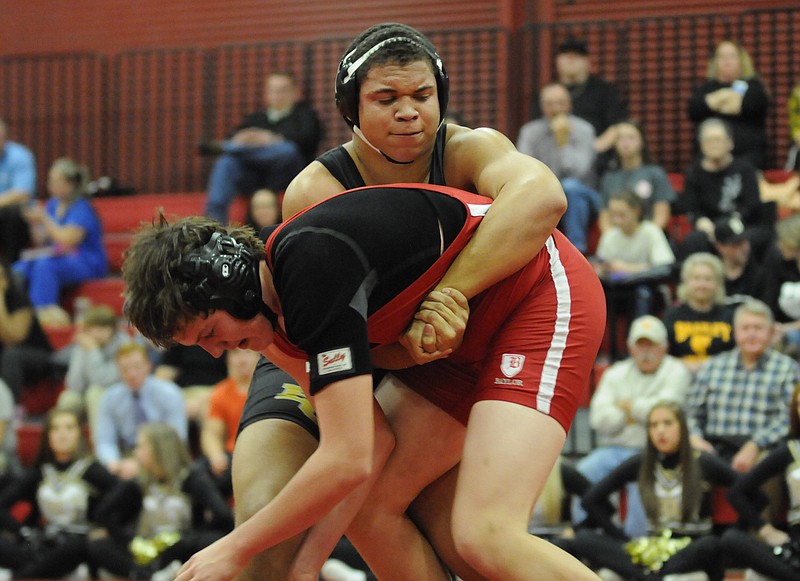 Bradley Central's D.J. Gibson, top, prepares to take down Baylor's Sam Reynolds Tuesday at Baylor. Gibson pinned Reynolds in the 220 weight class. 