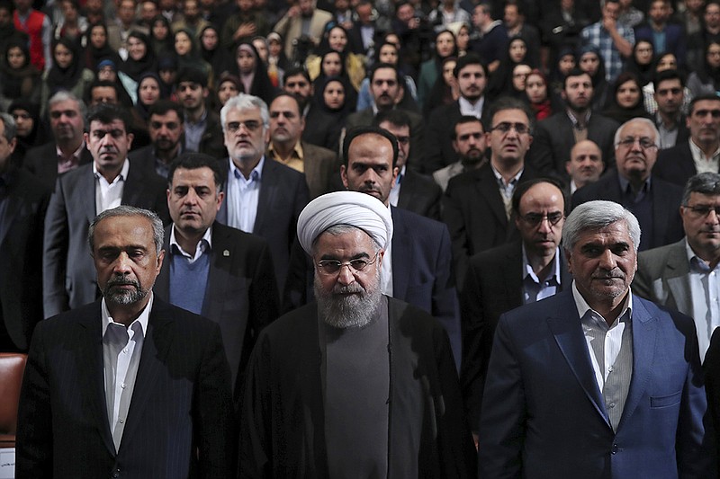
              In this photo released by official website of the office of the Iranian Presidency, President Hassan Rouhani, center, Science Minister Mohammad Farhadi, right, and head of the President's office Mohammad Nahavandian, left, listen to the national anthem at the start of a ceremony marking Student Day at Tehran University in Tehran, Iran, Tuesday, Dec. 6, 2016. Rouhani said Tuesday his country will not allow incoming U.S. President Donald Trump to "tear up" Tehran's landmark nuclear deal with world powers. His remarks underscore Iranian leaders' attempts to calm concerns over the future of the deal in the wake of Trump's election. (Iranian Presidency Office via AP)
            