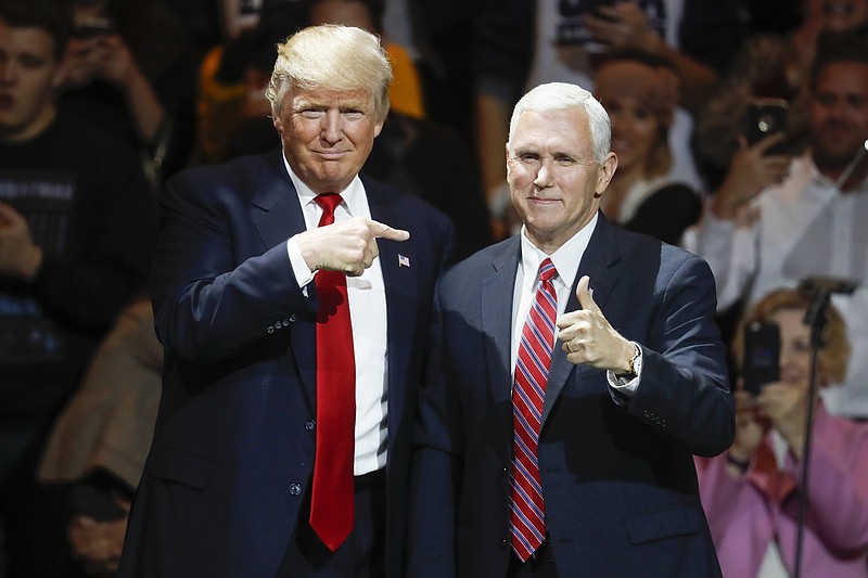 
              FILE - In this Thursday, Dec. 1, 2016, file photo, President-elect Donald Trump, left, and Vice President-elect Mike Pence acknowledge the crowd during the first stop of his post-election tour, in Cincinnati. The Heritage Foundation says Pence will deliver a speech Tuesday night, Dec. 6, 2016, to a conservative group at Trump’s new hotel in Washington, about areas of focus for the Trump administration in the first 200 days. (AP Photo/John Minchillo, File)
            