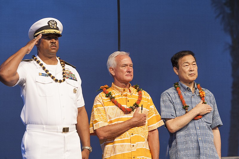 
              FILE - In this Aug. 15, 2015 file photo, U.S. Navy Read Adm. John Fuller, left, Honolulu mayor Kirk Caldwell, center, and then Nagaoka CityMayor Tomio Mori look on during a celebration marking the 70th anniversary of the end of World War II at Joint Base Pearl Harbor-Hickam, in Honolulu. The mayor of Nagaoka, Japan, the birthplace of the man who engineered the Pearl Harbor attack, is joining his counterpart of Honolulu to commemorate the 75th anniversary of the beginning of the four-year war between the two countries, as friends. Mayor Tatsunobu Isoda and eight other members of his delegation are formally invited as guests of Honolulu at both the main memorial on Wednesday, Dec. 7, 2016,  and a separate first ceremony Thursday, Dec. 8, co-organized by Japan and the U.S. (AP Photo/Marco Garcia, File)
            