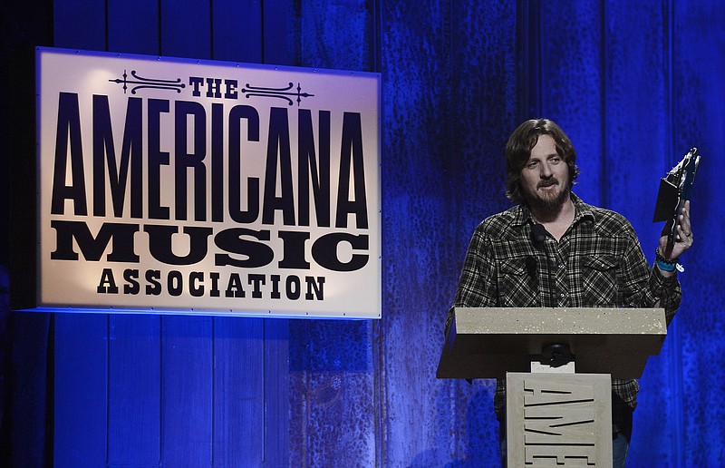 
              FILE- In this Sept. 17, 2014, file photo, Sturgill Simpson accepts the Emerging Artist of the Year Award during the Americana Music Honors and Awards show in Nashville, Tenn. Simpson's album, "A Sailor's Guide to Earth," was the surprise underdog nomination for the all-genre album of the year category on Tuesday, Dec. 6, 2016, when Grammy nominations were announced. (AP Photo/Mark Zaleski, File)
            