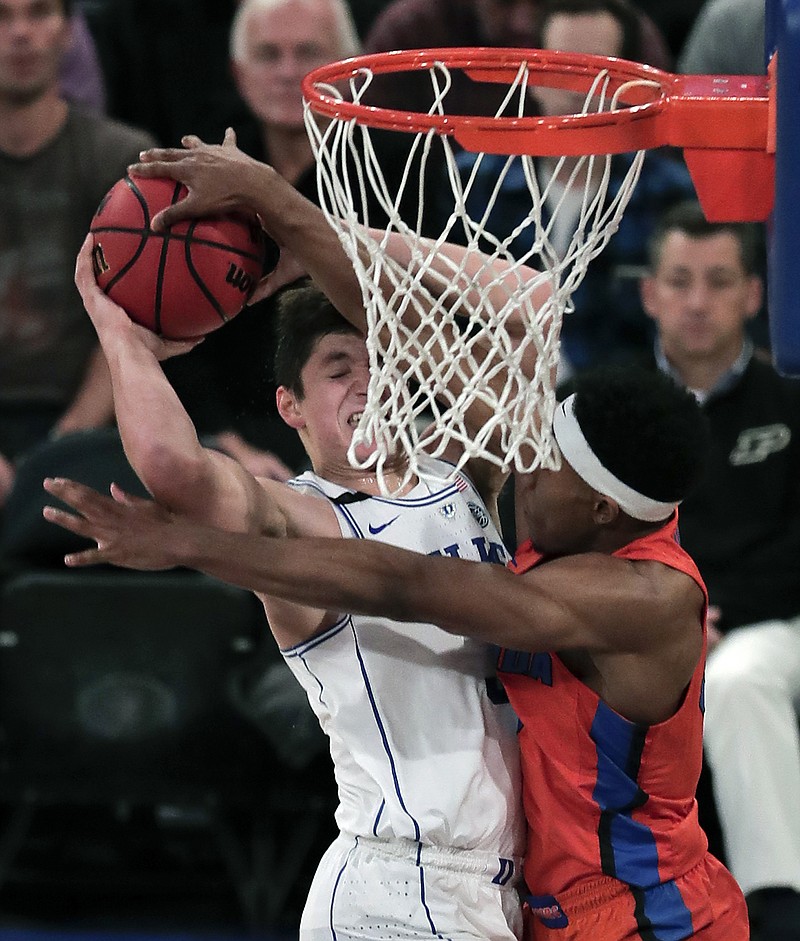
              Duke guard Grayson Allen, left, goes up for a shot against Florida guard KeVaughn Allen (5) in the first half of an NCAA college basketball game, Tuesday, Dec. 6, 2016, in New York. (AP Photo/Julie Jacobson)
            