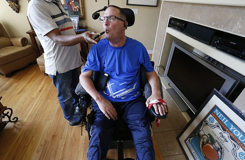 
              In this Aug. 21, 2015 photo, multiple sclerosis patient and author of the memoir "One day at a Time," David Sloan, who is a medical marijuana patient, exhales smoke from medical cannabis concentrate given to him with help from his caregiver, at Sloan's home in Highlands Ranch, south of Denver. Marijuana researchers have predominantly looked at how the drug affects young, developing brains. But increased pot use by older adults has scientists calling for more study of how aging influences drug use, and whether elderly pot users face potential health benefits or risks. (AP Photo/Brennan Linsley)
            