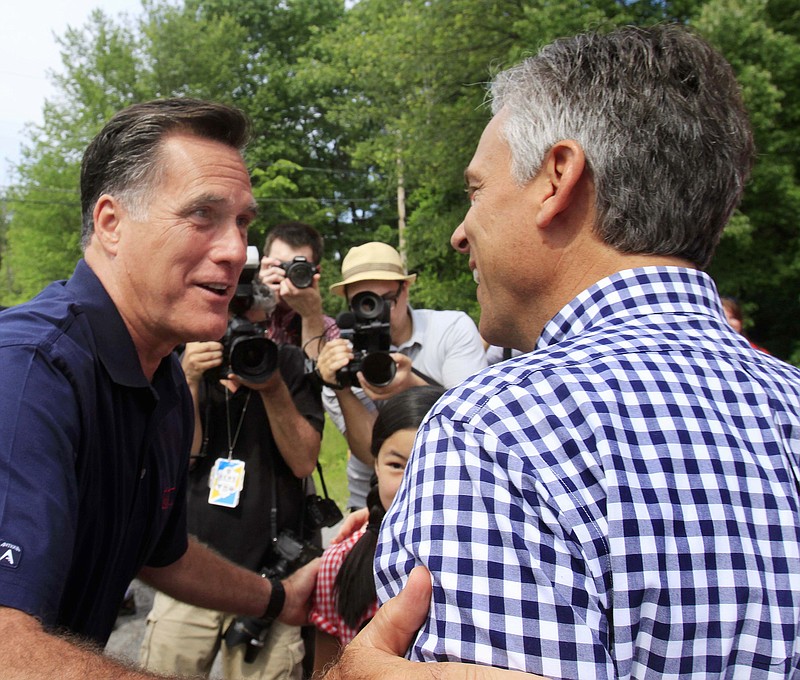 
              FILE - In this July 4, 2011 file photo, then-Republican presidential candidate, former Massachusetts Gov. Mitt Romney, left, greets fellow candidate, former Utah Gov. Jon Huntsman, Jr., prior to the start the Fourth of July parade in Amherst, N.H. They are distant cousins, courtly would-be presidents and scions of Mormon dynasties once enmeshed in long and unsuccessful races to the White House. Now Donald Trump, the brash Manhattanite who got there first, may have revived the rivalry between Romney and Huntsman by considering each of them for secretary of State. (AP Photo/Jim Cole, File)
            