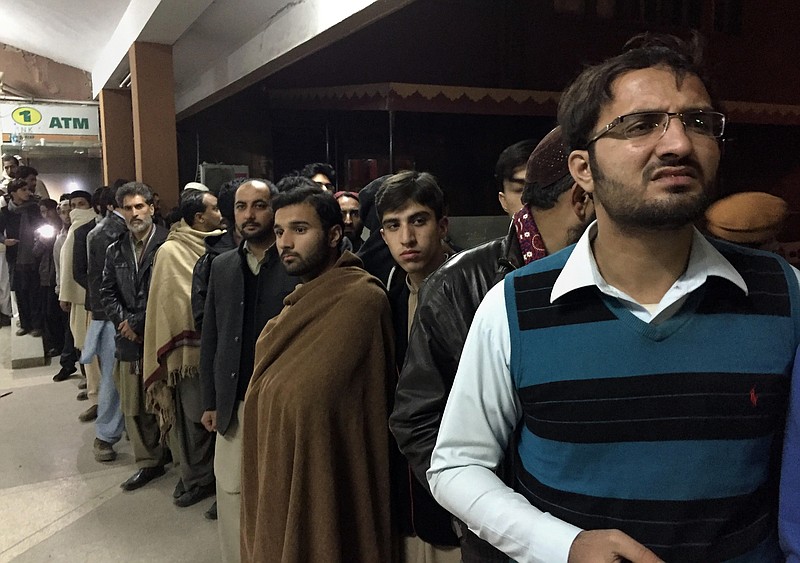 People gather outside the emergency ward, where authorities brought the bodies of plane crash victims, at a hospital, in Abbottabad, Pakistan, Wednesday, Dec. 7, 2016. Pakistan's national carrier says one of its planes has crashed shortly after takeoff from the northern city of Chitral with 48 people aboard. A spokesman for Pakistan's Civil Aviation Authority said Wednesday that the cause of the crash was unclear and there was believed to be little chance of finding survivors. (AP Photo/B.K. Bangash)