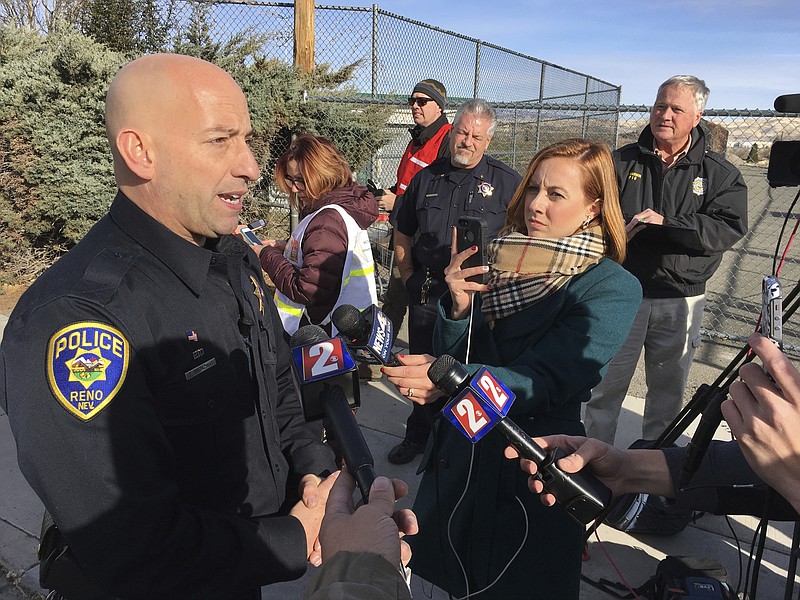 Reno police officer Tim Broadway briefs reporters outside Hug High School on the north side of Reno, Nev., on Wednesday, Dec. 7, 2016 after a Washoe County School District police officer shot a student following a disturbance at the school. The student was taken to a Reno hospital where there was no immediate word on the student's condition. (AP Photo/Scott Sonner)

