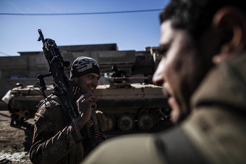 
              An Iraqi soldier from the 9th Infantry Division holds his machine gun while heading to the frontline in Shyma district in Mosul, Iraq, Tuesday, Dec. 6, 2016. Iraqi forces, backed the U.S.-led international coalition, launched a campaign in October to retake Mosul, the country's second largest city and IS's last major urban bastion in Iraq. (AP Photo/Manu Brabo)
            