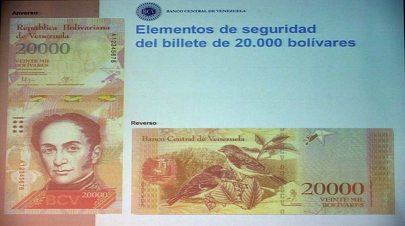 
              The front and back of the newly issued 20,000 Bolivar is displayed during a news conference in Caracas, Venezuela, Wednesday, Dec. 7, 2016. Venezuelan Central Bank President Nelson Merentes unveiled the new series of higher-denominated bills as triple-digit inflation and a currency meltdown leave the country's largest note worth just around 2 U.S. cents on the black market. (AP Photo/Fernando Llano)
            