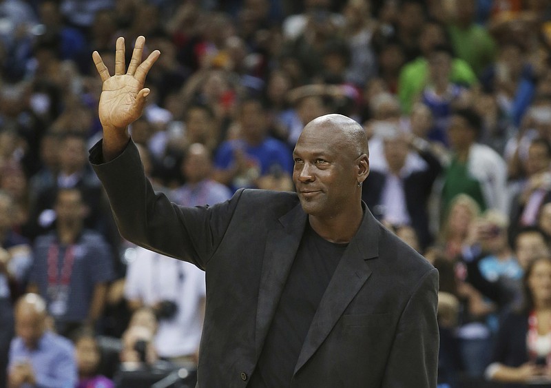 
              FILE - In this Oct. 11, 2015 file photo, NBA basketball legend Michael Jordan waves during the match of Charlotte Hornets against the Los Angeles Clippers at the 2015 NBA Global Games in Shenzhen, south China's Guangdong province. China's highest court ruled Thursday, Dec. 8, 2016, in favor of Jordan at the conclusion of a years-long trademark case. The former NBA star has been in dispute with a sportswear company based in southern China called Qiaodan Sports since 2012. (AP Photo/Kin Cheung, File)
            