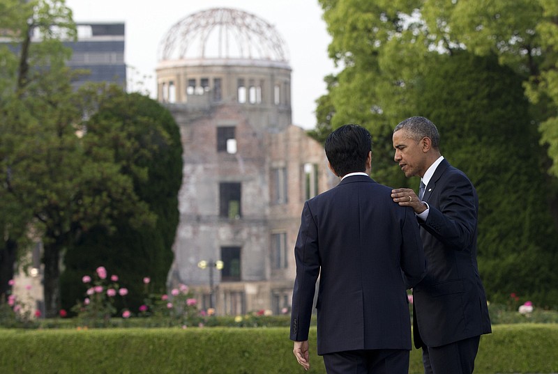 In this Friday, May 27, 2016, file photo, U.S. President Barack Obama and Japanese Prime Minister Shinzo Abe speak with the Atomic Bomb Dome seen at rear at the Hiroshima Peace Memorial Park in Hiroshima, western Japan. U.S. President Barack Obama risked criticism at home when he decided to visit the memorial to the 140,000 killed in the atomic bombing of the Japanese city during World War II. Japanese generally welcomed his visit and praised his speech which called on humankind to prevent war and pursue a world without nuclear weapons. (AP Photo/Carolyn Kaster, File)