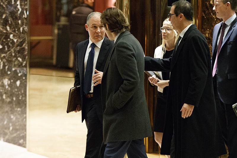 Oklahoma Attorney General Scott Pruitt, left, leaves a meeting with President-elect Donald Trump at Trump Tower, Monday, Nov. 28, 2016, in New York.