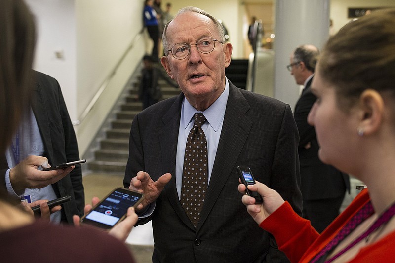 Sen. Lamar Alexander (R-Tenn.) speaks to reporters as he departs from the Senate floor after a vote on the 21st Century Cures Act, on Capitol Hill in Washington. The Senate joined the House in approving the bill, which increases funding for disease research, addresses weaknesses in the nation's mental health systems and vastly alters the regulation of drugs and medical devices. (Al Drago/The New York Times)