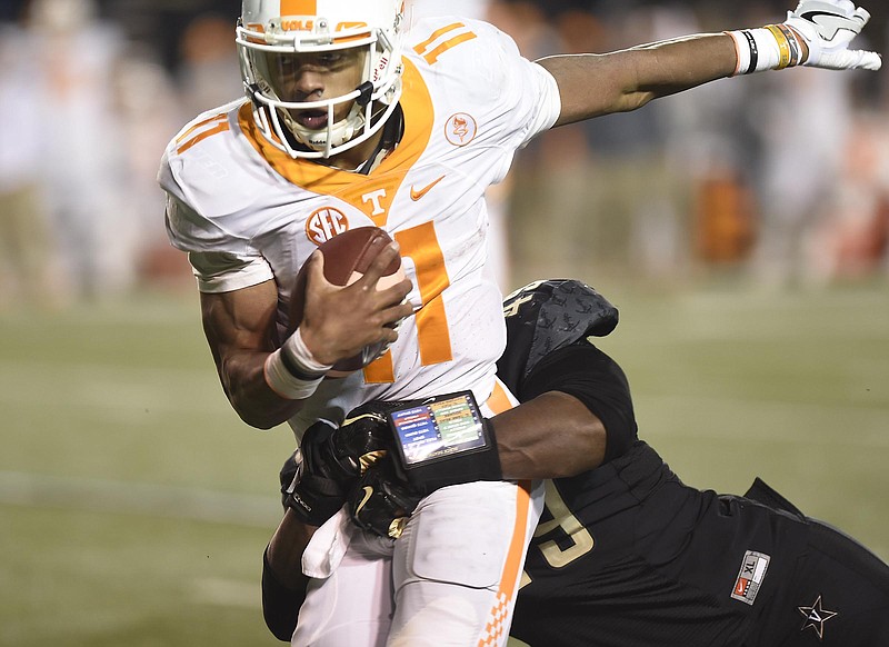 Tennessee's Joshua Dobbs (11) is tackled by Vanderbilt's Jonathan Wynn (49) late in the game.  The Tennessee Volunteers visited the Vanderbilt Commodores in a cross-state rivalry at Dudley Stadium on November 26, 2016.  