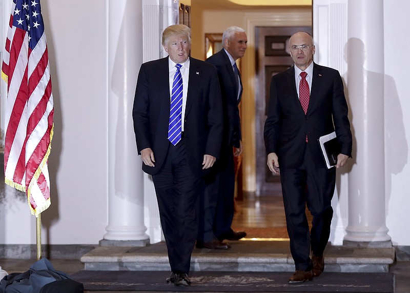 In this Nov. 19, 2016 file photo, President-elect Donald Trump walks with CKE Restaurants CEO Andy Puzder from Trump National Golf Club Bedminster clubhouse in Bedminster, N.J. (AP Photo/Carolyn Kaster)