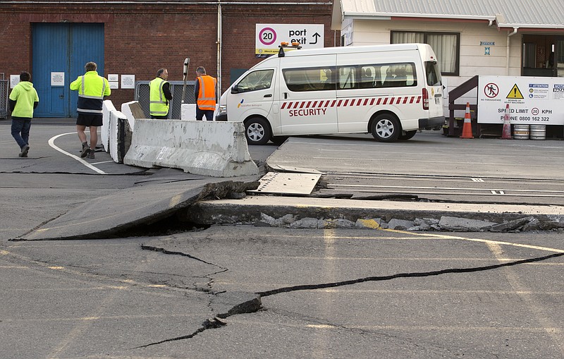 A paved road is lifted at the ports in Wellington, New Zealand, Monday, Nov. 14, 2016, following an earthquake. A powerful earthquake struck New Zealand's South Island early Monday, killing at least two people, causing damage to buildings and infrastructure, and prompting emergency services to warn people along the coast to move to higher ground to avoid tsunami waves. (Mark Mitchell/New Zealand Herald via AP)