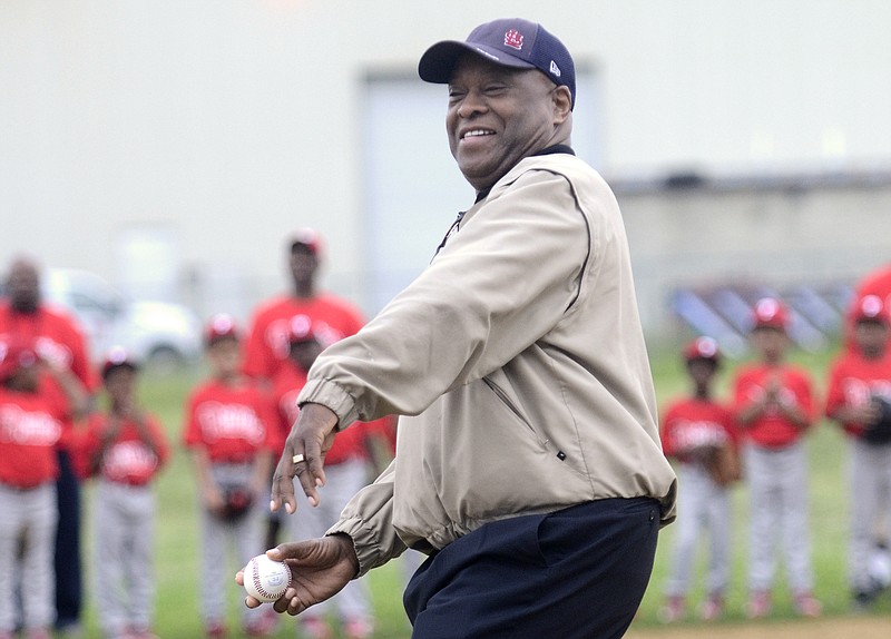 Administrator of the Department of Youth and Family Development, Lurone Jennings, throws out the first pitch at East Lake Community Center during opening day for the Restoring Baseball in Inner Cities program.