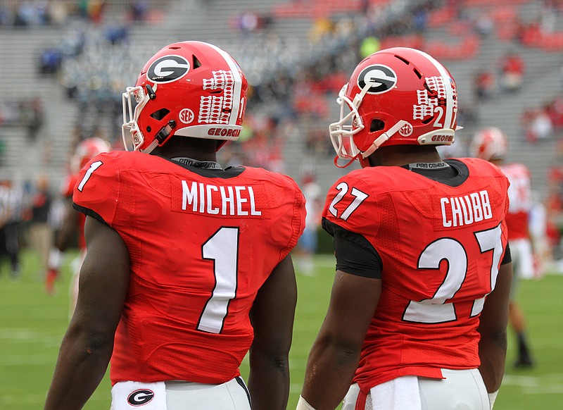 Georgia tailbacks Sony Michel (1) and Nick Chubb (27) are having to decide whether to return for a senior season.