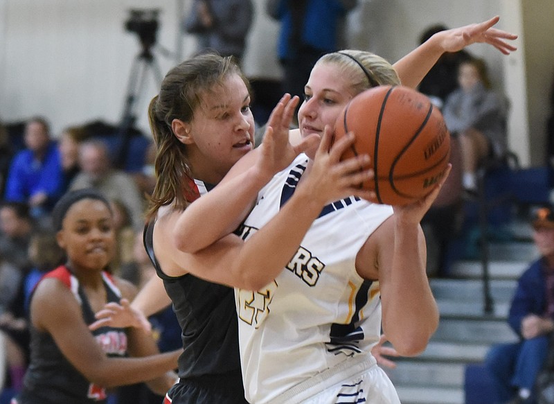 Signal Mountain's Janie Boals reaches in for the ball as Chattanooga Christian's Annika Fischer (23) tries to control a rebound in the second half Friday at CCS. Signal's Lady Eagles won 32-19.