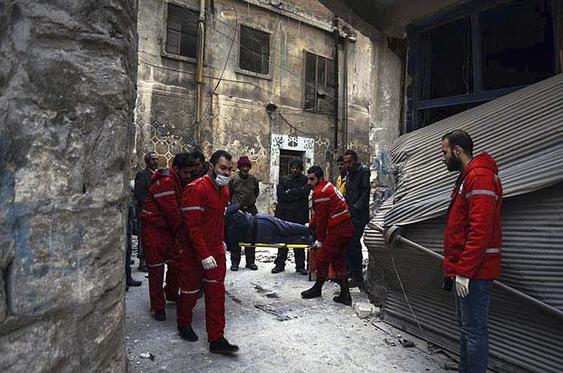 
              This Wednesday, Dec. 7, 2016 photo, released by the International Committee for the Red Cross, shows members of the Syrian Arab Red Crescent carrying a patient on stretcher out of a medical facility in the Old City of Aleppo, Syria. The ICRC said it evacuated 148 disabled or civilians in need of urgent care from the facility, now under Syrian government control. ICRC said in a statement Thursday the evacuation was possible after fighting calmed down in the area. (Syrian Arab Red Crescent/Noor Hazouri via AP)
            