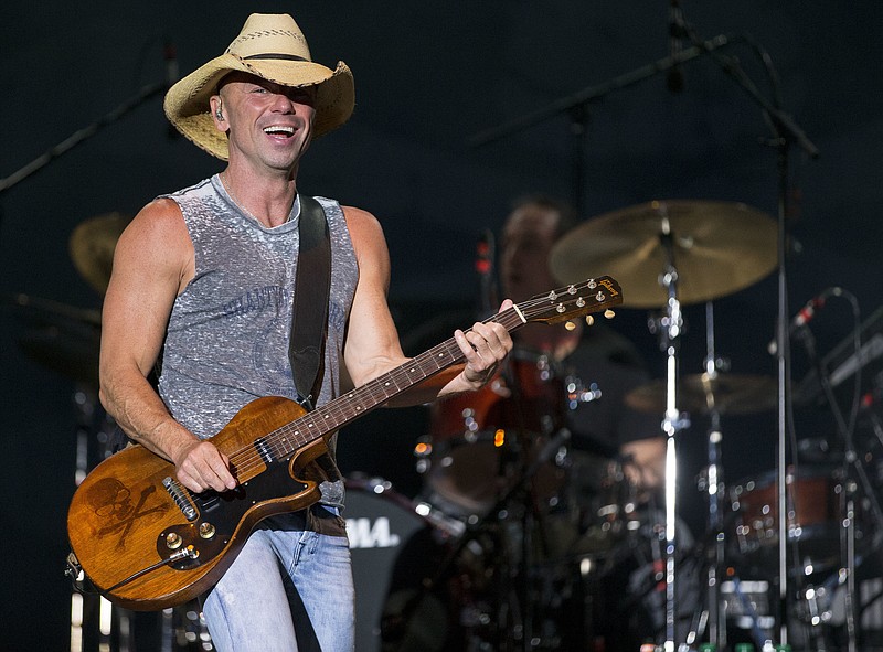 
              FILE - In this April 3, 2016, file photo, Kenny Chesney performs at the 4th Annual ACM Party for a Cause Festival in Las Vegas. Chesney and the Country Music Association announced Friday, Dec. 9, they are collectively donating $500,000 to the Dolly Parton Foundation My People Fund, which was created to provide $1,000 each month to Sevier County families whose homes were damaged or destroyed by the wildfires. (Photo by Eric Jamison/Invision/AP, File)
            