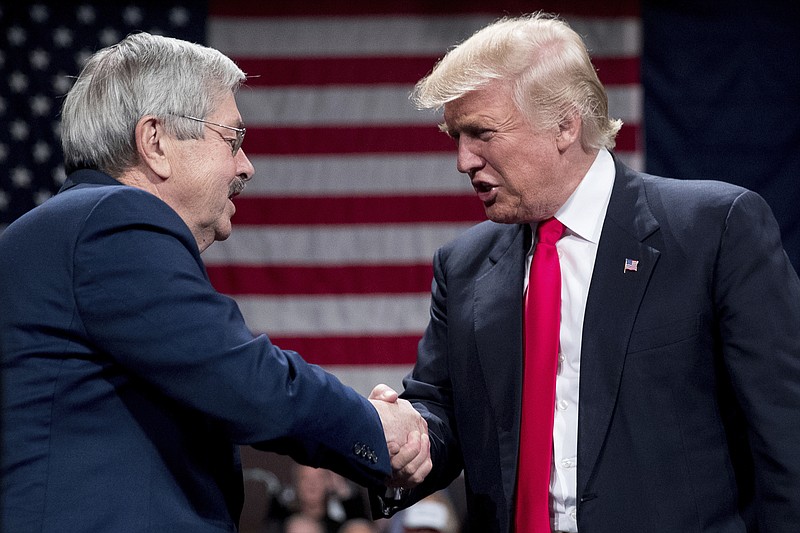 
              President-elect Donald Trump, right, greets Iowa Gov. Terry Branstad, left, as he welcomes him to the stage during a rally at Hy-Vee Hall, Thursday, Dec. 8, 2016, in Des Moines. Branstad has accepted Trump's offer to become U.S. ambassador to China. (AP Photo/Andrew Harnik)
            