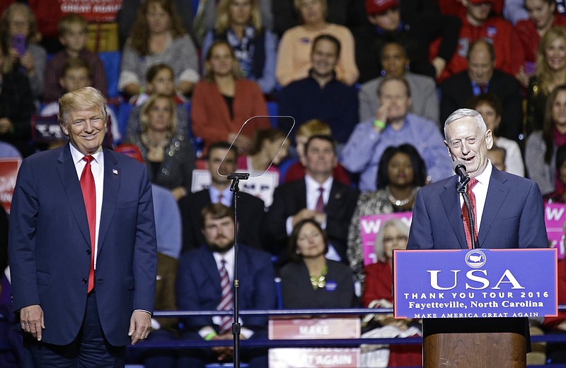 
              President-elect Donald Trump, left, listens to retired United States Marine Corps General James Mattis after appointing Mattis as upcoming Secretary of Defense while speaking to supporters during a rally in Fayetteville, N.C., Tuesday, Dec. 6, 2016. (AP Photo/Gerry Broome)
            