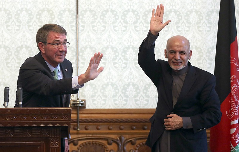 
              Afghan President Ashraf Ghani, right, and U.S. Defense Secretary Ash Carter, left, wave after a press conference at presidential palace in Kabul, Afghanistan, Friday, Dec. 9, 2016. Defense Secretary Ash Carter said Friday that the United States will stick with Afghanistan for years to come. (AP Photos/Massoud Hossaini)
            