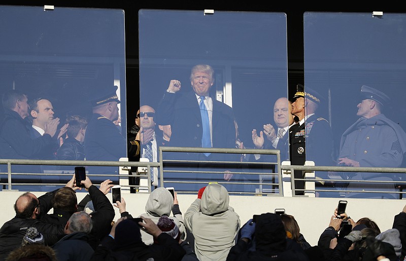 
              President-elect Donald Trump acknowledges spectators during the first half of the Army-Navy NCAA college football game in Baltimore, Saturday, Dec. 10, 2016. (AP Photo/Patrick Semansky)
            