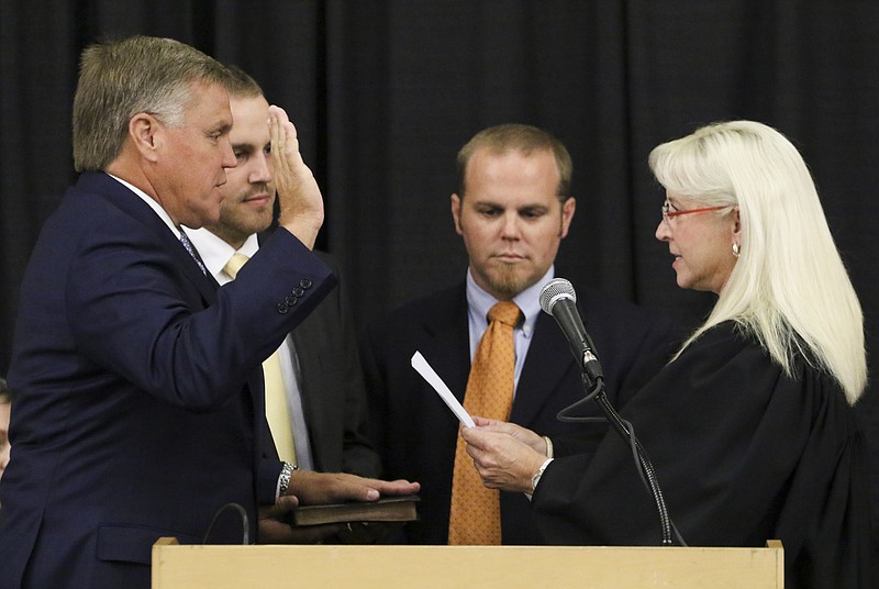 Marty Haynes, left, is sworn in as the Assessor of Property during the Inaugural Ceremony of Hamilton Count Officials at the Chattanooga Convention Center on September 1, 2016.