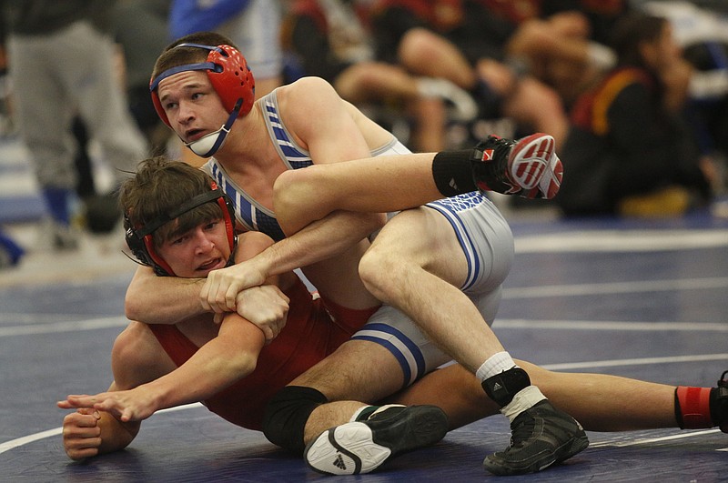 Cleveland High School wrestler Colton Landers, top, flips Baylor's Luke Fraley before pinning him during the Cleveland Duals on Saturday. Landers was undefeated during the Blue Raiders' championship run.