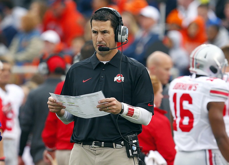 
              FILE - In this Nov. 16, 2013, file photo, Ohio State Defensive Coordinator Luke Fickell during the NCAA college football game against Illinois  in Champaign, Ill. Cincinnati has hired Fickell on Saturday, Dec. 10, 2016, as its head coach, turning to the Buckeye state native to re-establish a program that has slipped in recent years. (AP Photo/Jeff Haynes, File)
            