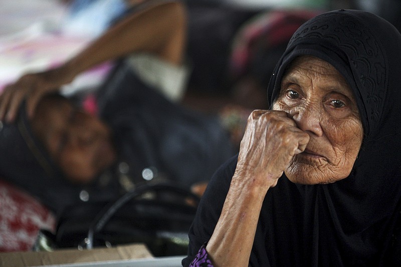 
              Earthquake survivors rest and reflect at a temporary shelter in Ulim, Aceh province, Indonesia, Friday, Dec. 9, 2016. A large number of people were killed in the quake that hit the northeast of the province on Sumatra before dawn Wednesday. Hundreds of people were injured and thousands buildings destroyed or heavily damaged. (AP Photo/Binsar Bakkara)
            