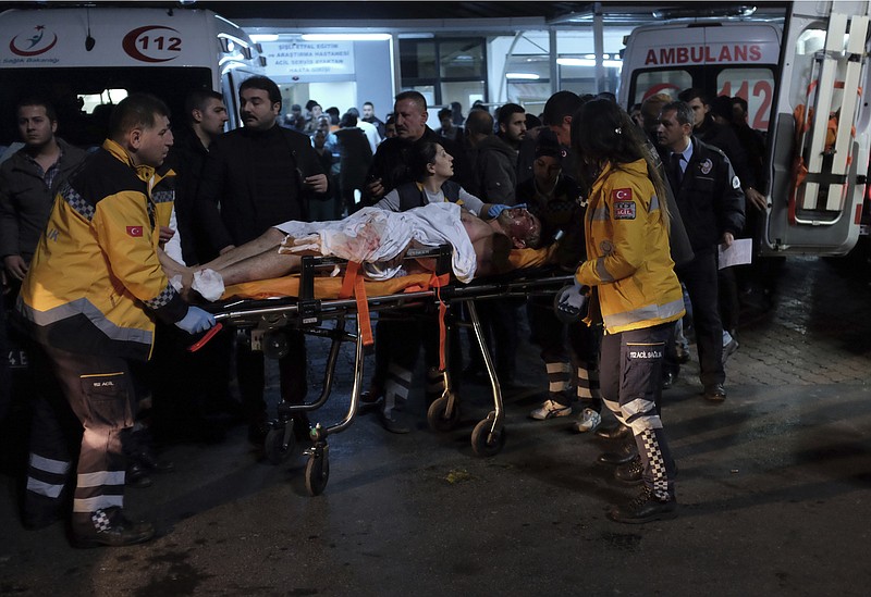 Rescue and medics carry a wounded person after attacks in Istanbul, late Saturday, Dec. 10, 2016. Two explosions struck Saturday night outside a major soccer stadium in Istanbul after fans had gone home, an attack that wounded about 20 police officers, Turkish authorities said. One of the blasts was thought to be a car bomb. Turkish authorities have banned distribution of images relating to the Istanbul explosions within Turkey.(AP Photo/Cansu Alkaya)

