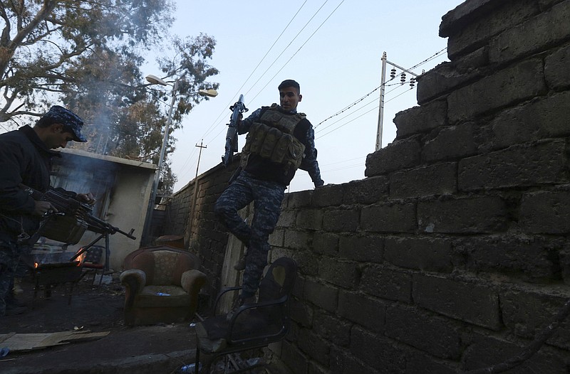 
              A policeman secures houses as Iraqi federal police forces advance towards the Islamic State militant held city of Mosul, Iraq, Saturday, Dec. 10, 2016. An Iraqi commander says reinforcements have been sent to eastern Mosul after a major Islamic State counterattack drove troops back last week, further slowing a nearly two-month-old offensive to retake the city. (AP Photo/Hadi Mizban)
            